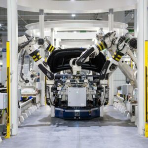 High-tech robots assembling a car in a modern factory setting, showcasing automation.